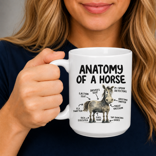 A person holding a white ceramic mug with a humorous 'Anatomy of a Horse' graphic printed on it, wearing a navy blue shirt against a neutral gray background. From Coffee and Moo NZ.
