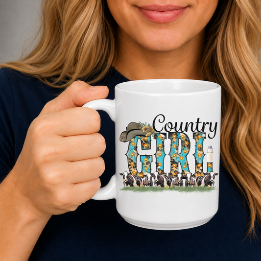 A woman holding a white ceramic mug with a colorful 'Country GIRL' graphic featuring a cowboy hat, flowers, and a herd of cows. From Coffee and Moo NZ
