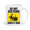 Do Not Disturb Gamer at Work gaming coffee mug featuring, bold black lettering and a yellow and black graphic of a gamer at a computer, from Coffee and Moo.