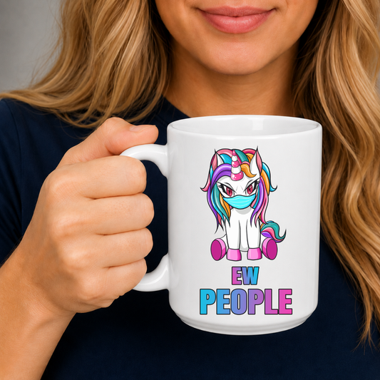A person holding a white ceramic mug with a colorful cartoon unicorn graphic and the text 'EW PEOPLE'. from Coffee and Moo.