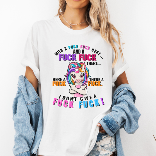 A woman wearing a white graphic t-shirt with a colorful cartoon unicorn and bold profane text, "With a fuck fuck here… and a fuck fuck there… here a fuck, there a fuck… I don't give a fuck!", styled with an open light-wash denim jacket against a plain white background. From Coffee and Moo NZ