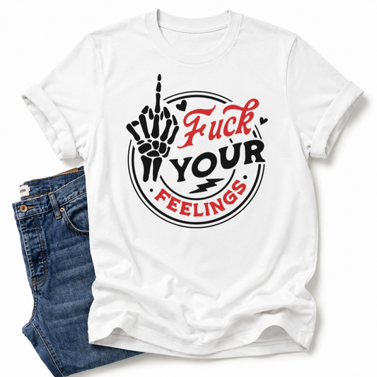 A white short-sleeve graphic T-shirt laid flat with blue jeans partially visible underneath at the lower left. The shirt has a large front graphic reading 'Fuck Your Feelings' in red and black, with a hand raised in the middle-finger gesture and circular line art. Grab yours from Coffee and Moo NZ.