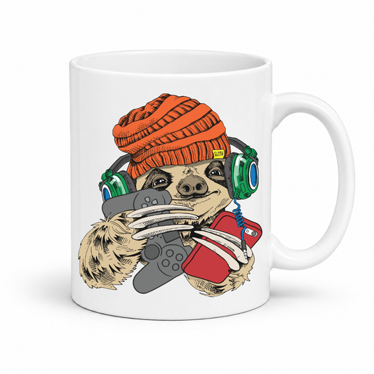 A white ceramic mug featuring a cartoon sloth wearing an orange knit beanie, green headphones, and holding a grey game controller and a red smartphone. Grab your gaming sloth mug from Coffee and Moo NZ.