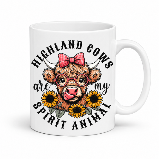 A white ceramic mug featuring a cute graphic of a Highland cow wearing round glasses and a pink bow, surrounded by yellow sunflowers and the text 'HIGHLAND COWS are my SPIRIT ANIMAL'. from Coffee and Moo NZ.