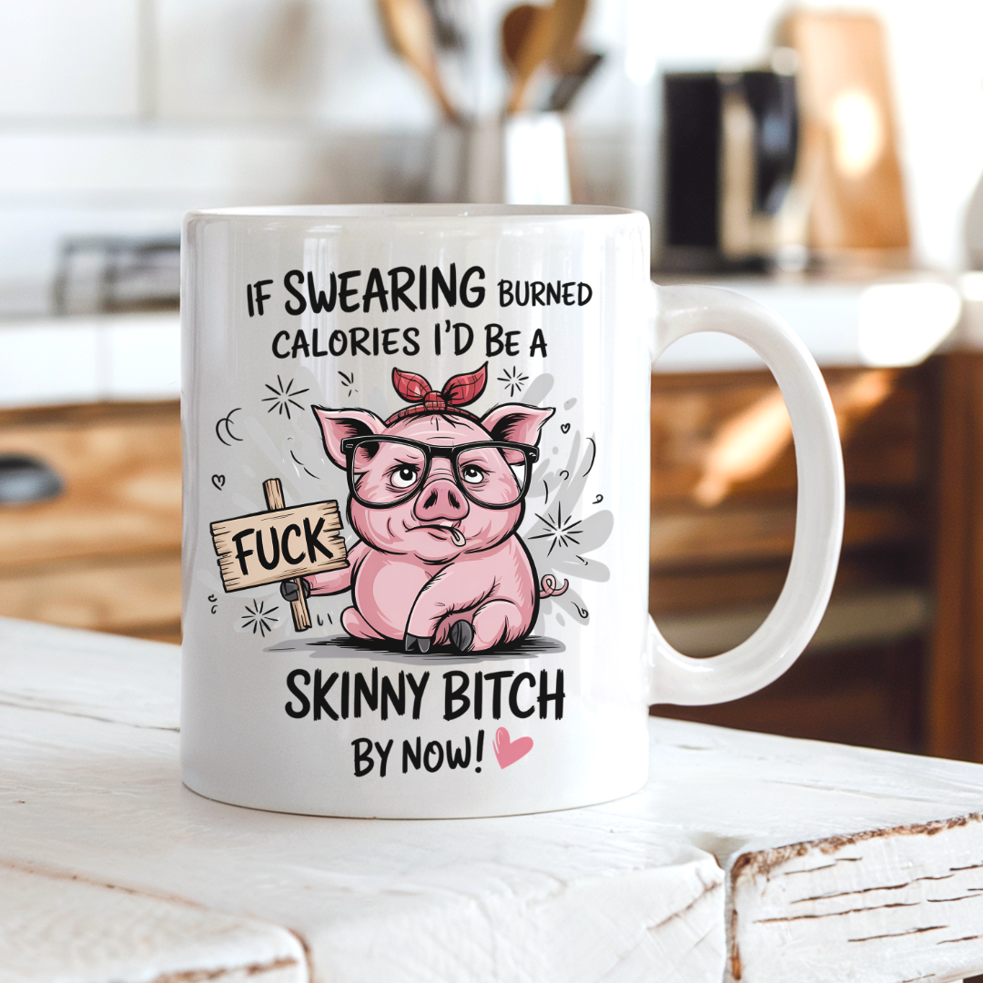A white ceramic coffee mug with a humorous cartoon graphic of a pink pig wearing glasses and a red bandana, holding a sign that says 'FUCK'. The text above and below reads 'IF SWEARING BURNED CALORIES I'D BE A SKINNY BITCH BY NOW!'. from Coffee and Moo.