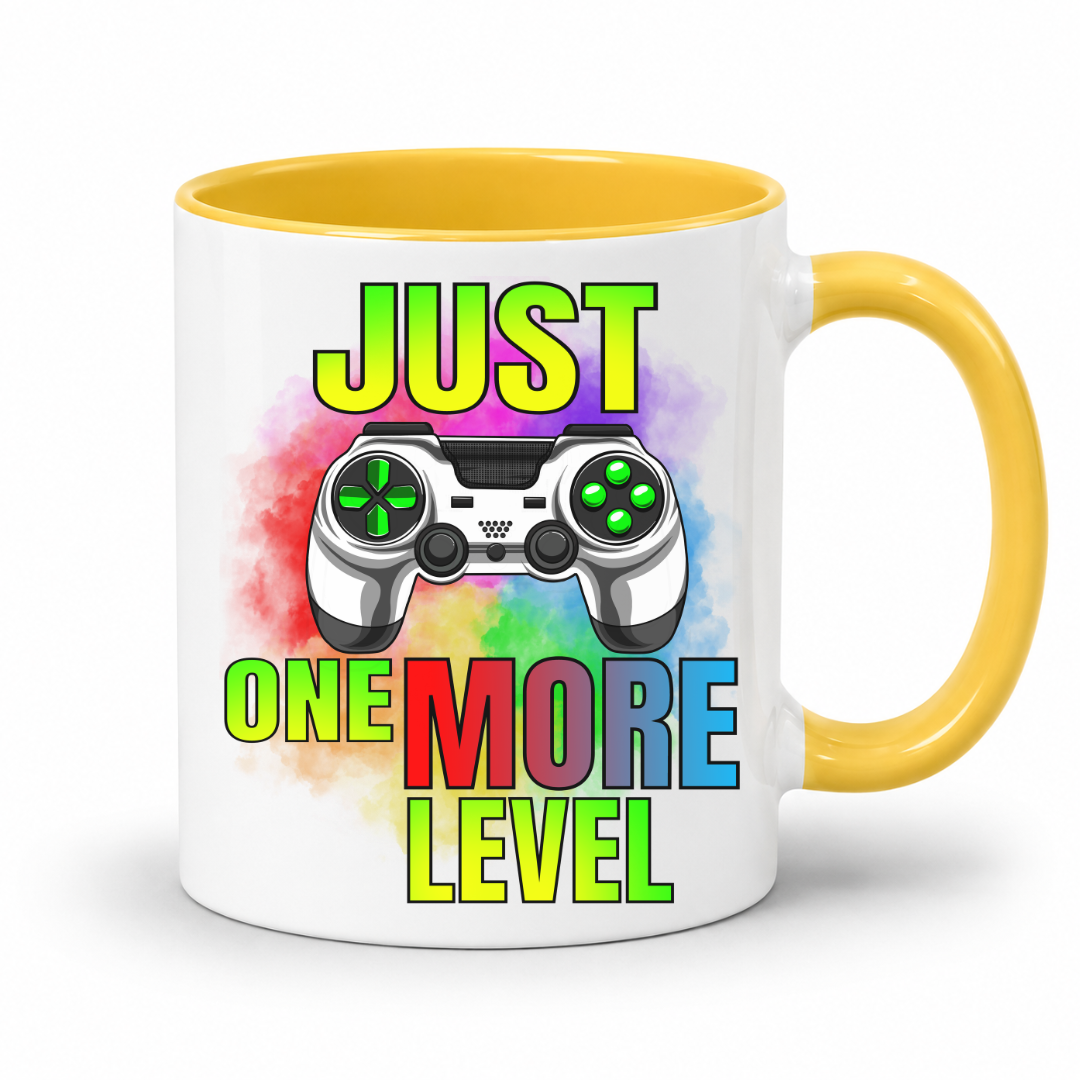 Just One More Level gaming coffee mug showing a colourful controller, rainbow watercolour background and bold "Just One More Level" design, with a yellow inner and handle, from Coffee and Moo.