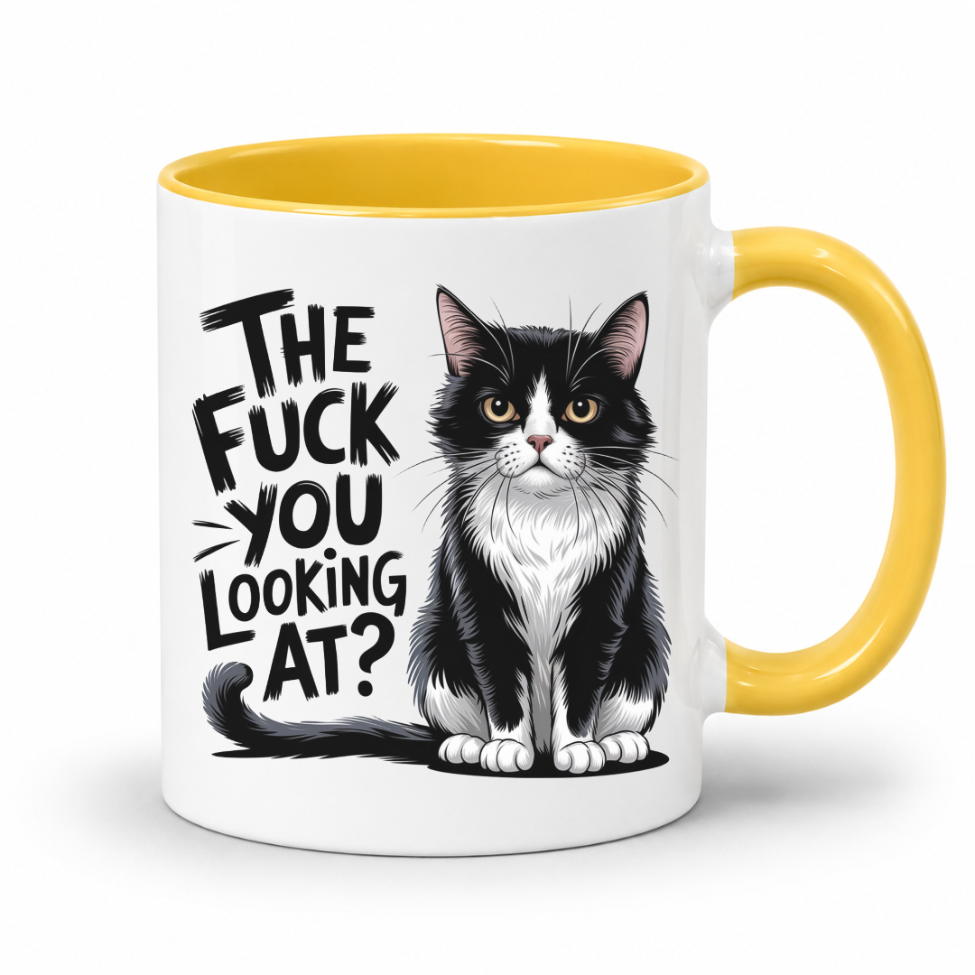 A white ceramic mug with a yellow interior and yellow handle, featuring a black-and-white cat illustration and the text 'THE FUCK YOU LOOKING AT?' on the front, shown on a clean white background.