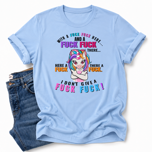 A light blue graphic t-shirt with a cartoon unicorn and profane text, styled flat-lay next to a pair of blue jeans on a white background.