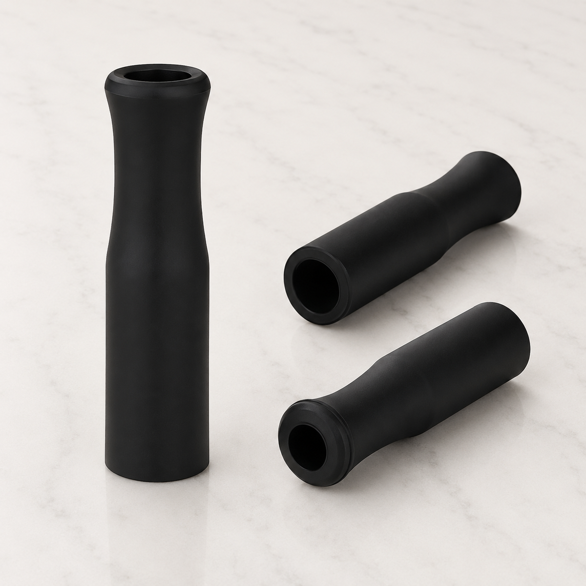 Three black rubber straw tips shown from different angles, designed to fit reusable drinking straws. from coffee and moo nz.