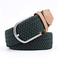 Dark green woven belt with a brown faux leather trim and silver buckle on a white background. Purchase from Coffee and Moo