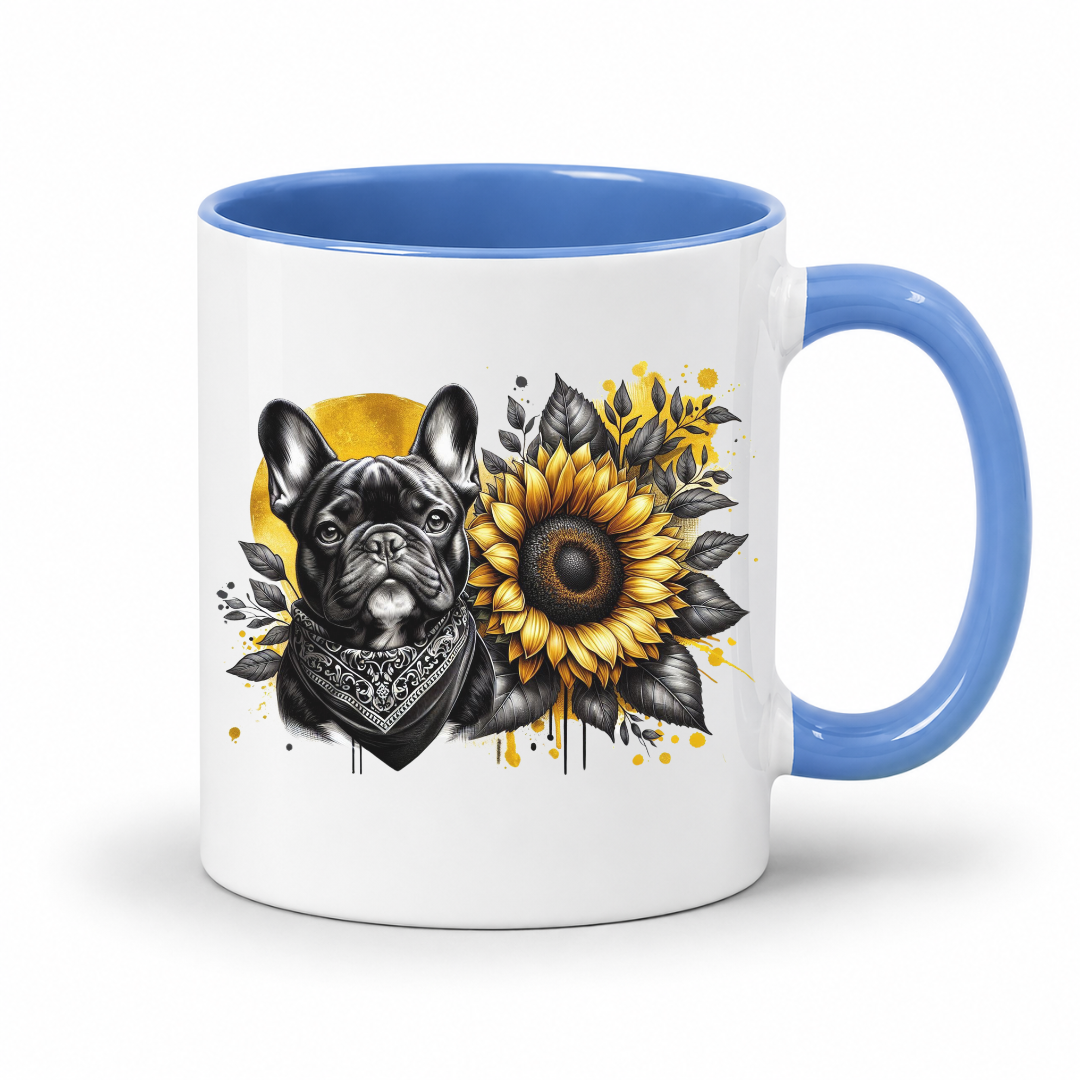 A white ceramic mug with a blue interior and handle, featuring a graphic print of a black French bulldog wearing a bandana next to a yellow sunflower with black leaves on a white background. Grab your frenchie mug from Coffee and Moo NZ
