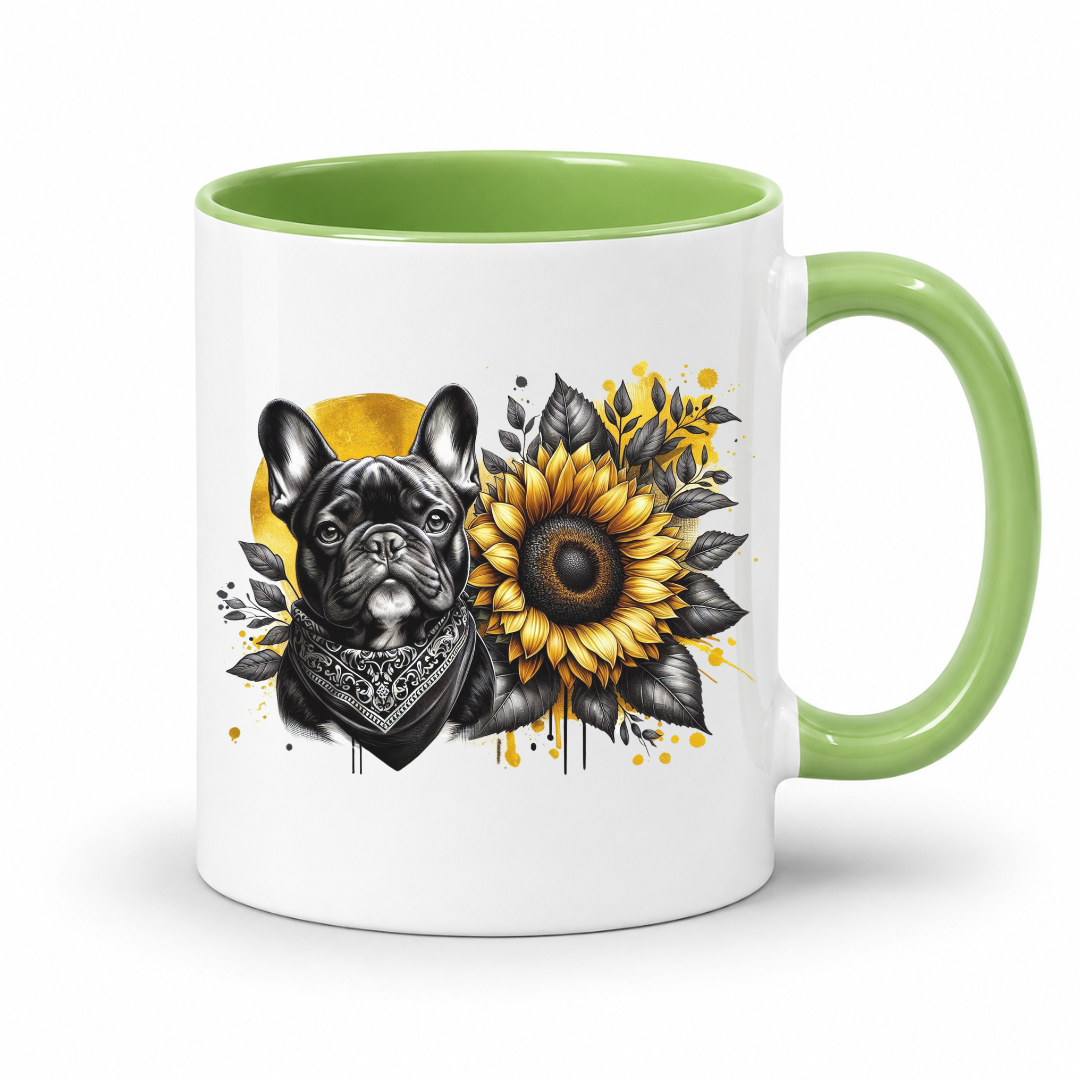 A white ceramic mug with a light green interior and handle, featuring a graphic print of a black French Bulldog wearing a bandana next to a yellow sunflower with black leaves on a white background. Grab your frenchie mug from Coffee and Moo NZ