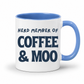 A white ceramic coffee mug with a blue interior, blue handle, and navy blue printed text reading 'HERD MEMBER OF COFFEE & MOO' on a clean white background. Grab your mug from Coffee and Moo NZ.