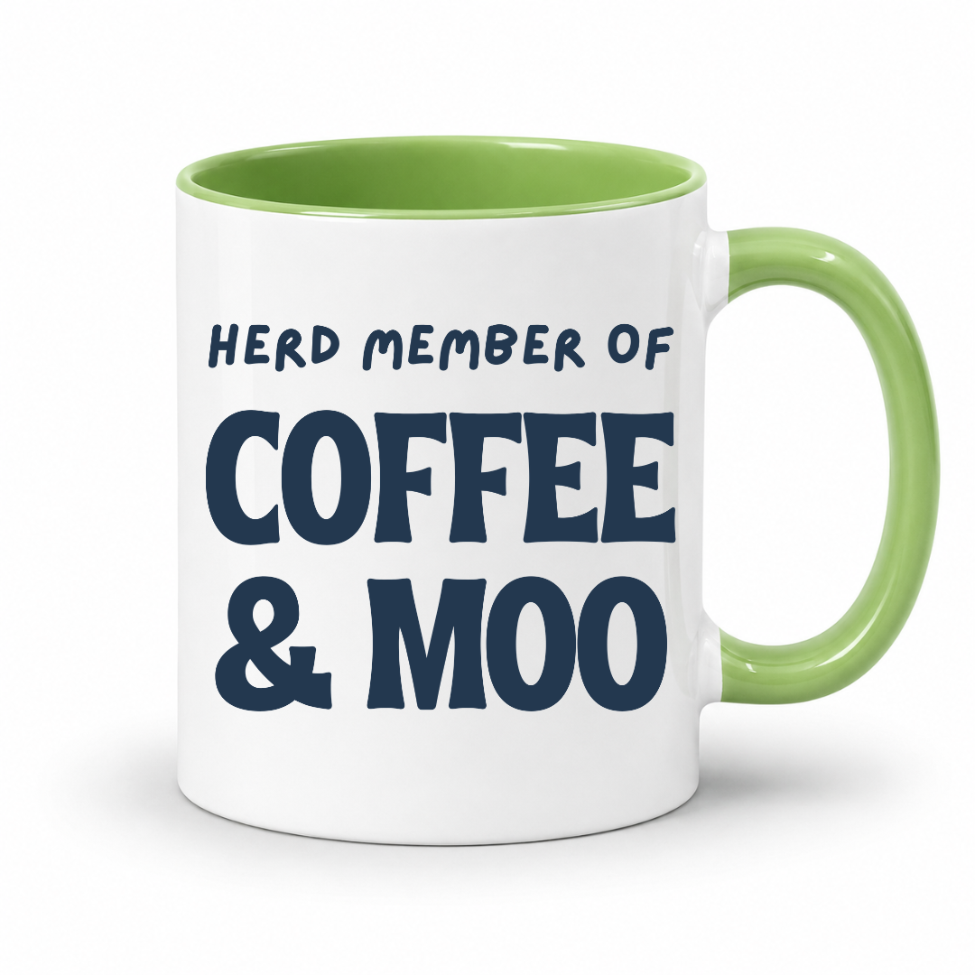 A white ceramic coffee mug with a light green interior and handle, featuring the printed text 'HERD MEMBER OF COFFEE & MOO' in dark navy blue lettering, shown on a clean white background. Grab your mug from Coffee and Moo NZ.