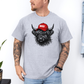 A man wearing a grey t-shirt with a graphic of a black highland cow wearing a red cap that says 'BOSSY' in white text. The man is also wearing light blue jeans, standing against a white wall. Grab your bossy tee from Coffee and Moo NZ.