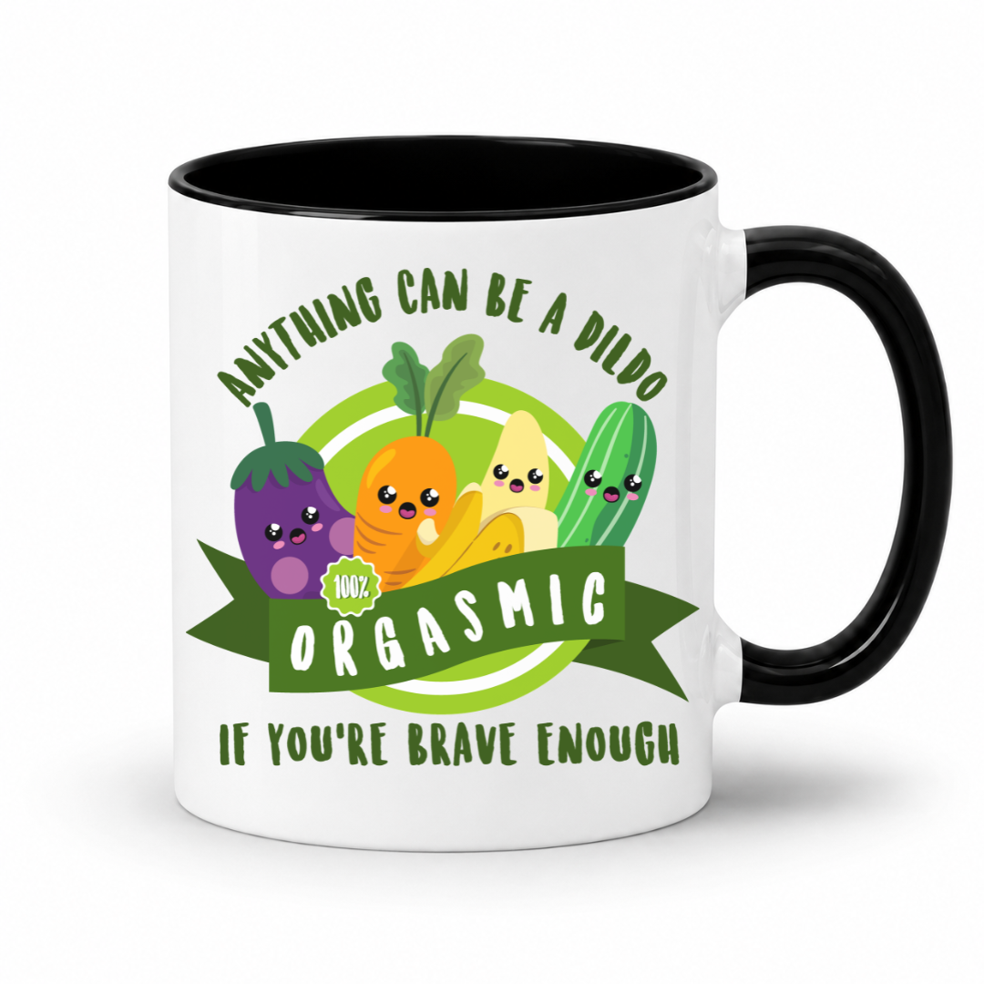 A white mug with a black inner and handle, featuring an image of smiling cartoon vegetables and the words "Anything Can Be a Dildo If You're Brave Enough", Grab yours from from Coffee & moo nz.