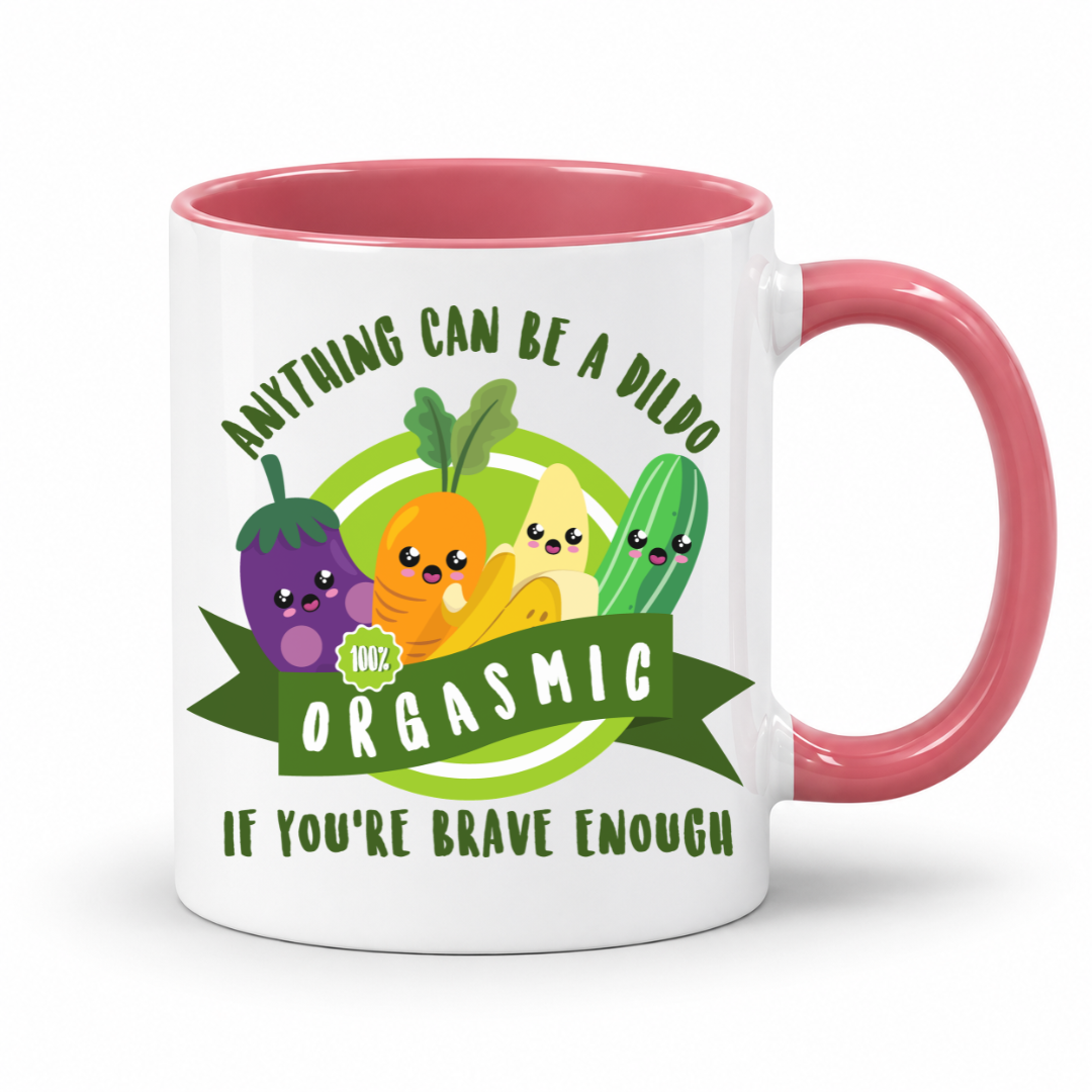 A white mug with a pink inner and handle, featuring an image of smiling cartoon vegetables and the words "Anything Can Be a Dildo If You're Brave Enough", Grab yours from from Coffee & moo nz.