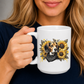 A woman holding a white ceramic mug with a printed graphic of a beagle dog surrounded by yellow sunflowers and a black bandana. Grab your mug from Coffee and Moo NZ.