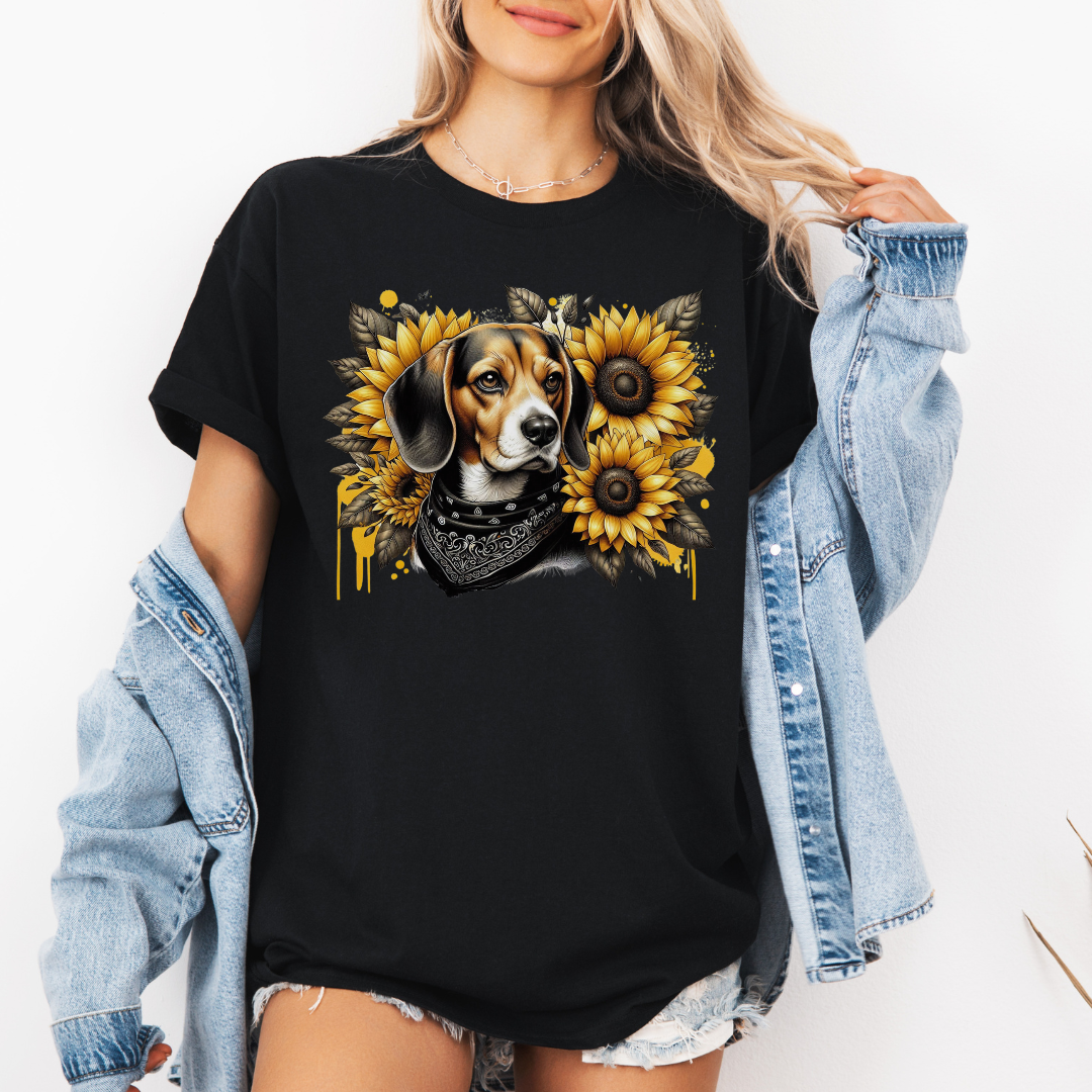 A woman wearing a black graphic t-shirt with a beagle dog and sunflower design, styled with an open light blue denim jacket. Grab your tee from Coffee and Moo.