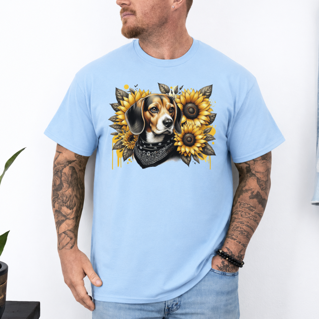 A man wearing a light blue crewneck t-shirt with a graphic print of a beagle dog surrounded by yellow sunflowers and a black bandana. Grab your tee from Coffee and Moo.
