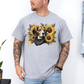 A man wearing a grey crewneck t-shirt with a graphic print of a beagle dog surrounded by yellow sunflowers and a black bandana. Grab your tee from Coffee and Moo.