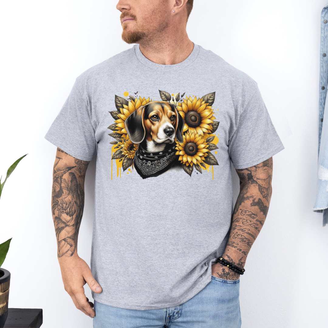 A man wearing a grey crewneck t-shirt with a graphic print of a beagle dog surrounded by yellow sunflowers and a black bandana. Grab your tee from Coffee and Moo.