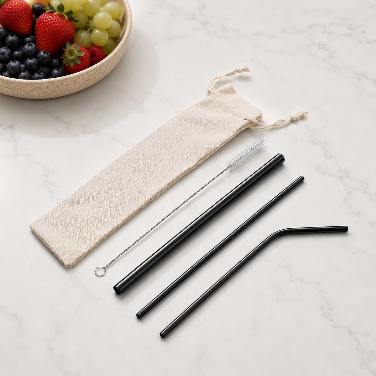 Black reusable stainless steel straw set featuring three straws, cleaning brush and beige drawstring pouch. From coffee and moo nz.