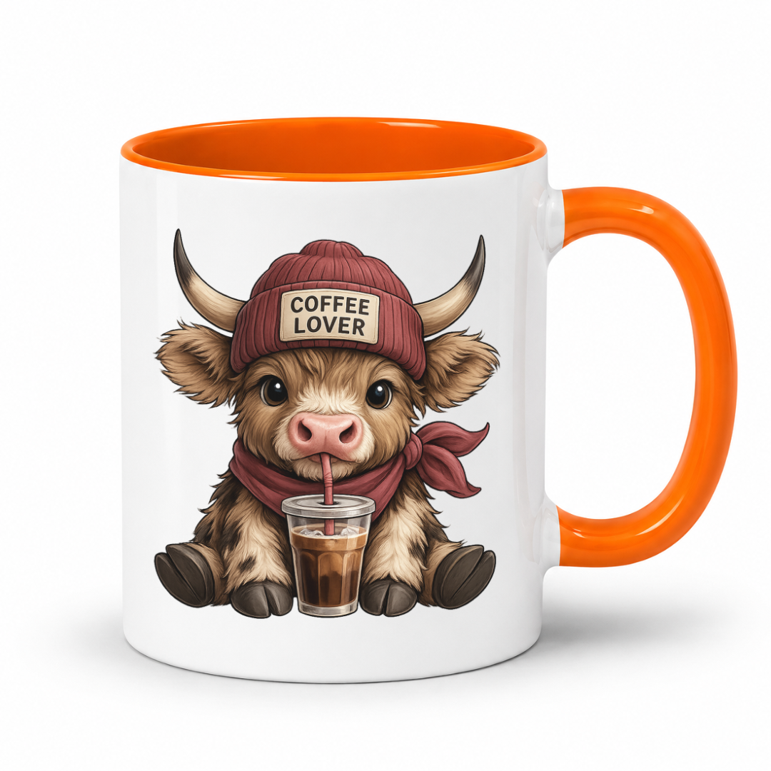 A white ceramic coffee mug with a bright orange handle and interior, featuring a cartoon Highland cow wearing a red beanie that says 'COFFEE LOVER' and holding a drink. from Coffee and Moo.