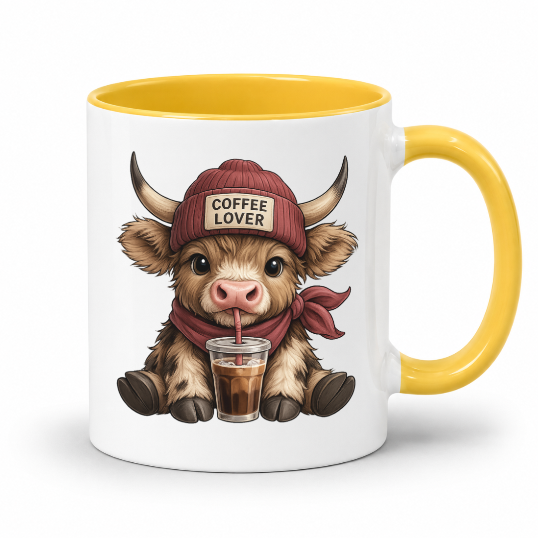 A white ceramic coffee mug with a yellow interior and handle, featuring a cartoon illustration of a cute Highland cow wearing a red beanie that says 'COFFEE LOVER' and holding a drink. from Coffee and Moo.