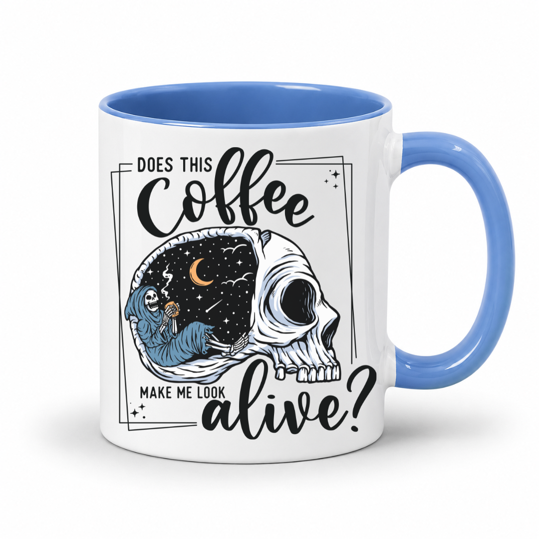 while mug with a blue handle and inner with a graphic on it that features a skull with one half showing a starry night sky with a crescent moon and a skeleton holding a coffee, accompanied by the text 'DOES THIS Coffee MAKE ME LOOK alive?'. Grab yours from Coffee and Moo NZ.