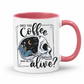 while mug with a pink handle and inner with a graphic on it that features a skull with one half showing a starry night sky with a crescent moon and a skeleton holding a coffee, accompanied by the text 'DOES THIS Coffee MAKE ME LOOK alive?'. Grab yours from Coffee and Moo NZ.