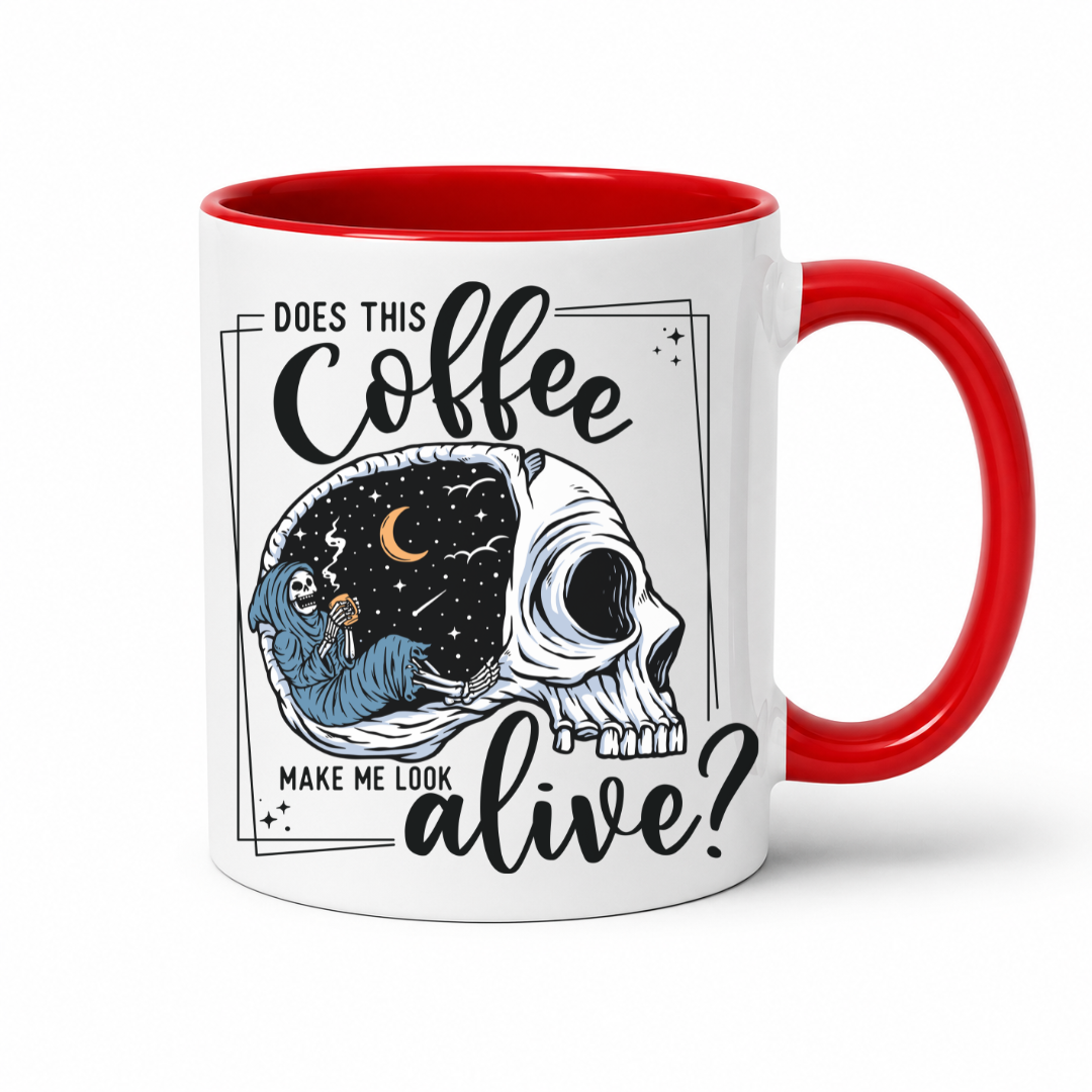while mug with a Red handle and inner with a graphic on it that features a skull with one half showing a starry night sky with a crescent moon and a skeleton holding a coffee, accompanied by the text 'DOES THIS Coffee MAKE ME LOOK alive?'. Grab yours from Coffee and Moo NZ.