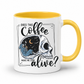 while mug with a yellow handle and inner with a graphic on it that features a skull with one half showing a starry night sky with a crescent moon and a skeleton holding a coffee, accompanied by the text 'DOES THIS Coffee MAKE ME LOOK alive?'. Grab yours from Coffee and Moo NZ.
