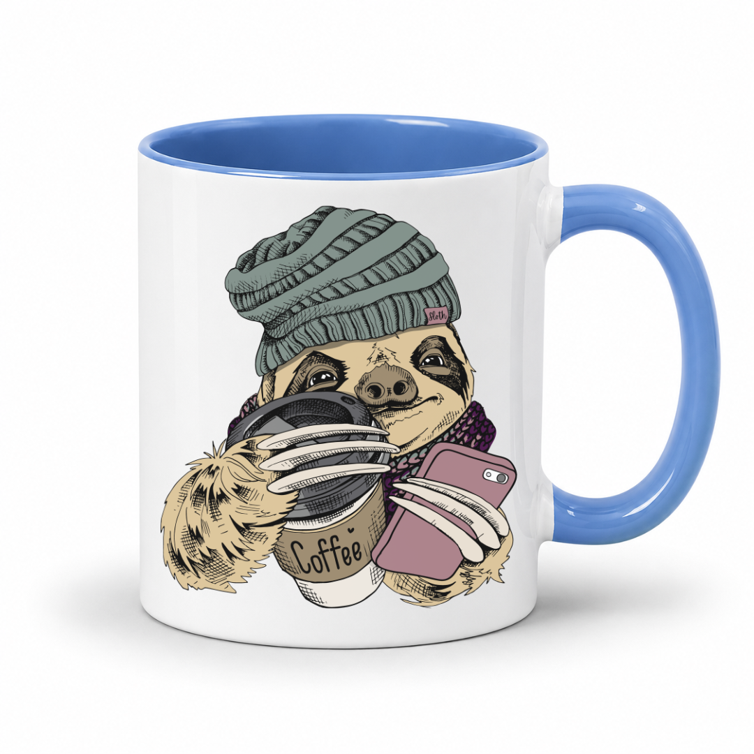 A white ceramic coffee mug with a blue handle and blue interior, featuring a cartoon sloth wearing a knit beanie and holding a coffee cup and a pink smartphone. Grab your mug from Coffee and moo NZ.
