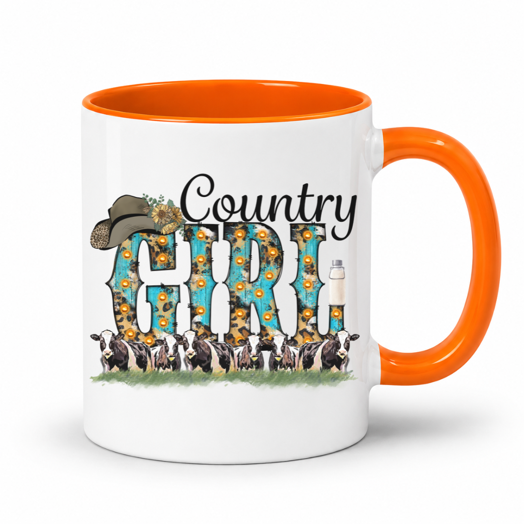 A white ceramic coffee mug with a bright orange handle and interior, featuring a 'Country Girl' graphic design with sunflowers, cows, and a cowboy hat.  From Coffee and Moo NZ