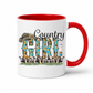 A white ceramic mug with a red interior and red handle, featuring a 'Country Girl' graphic with a cowboy hat, sunflowers, cows, and a lighthouse.  From Coffee and Moo NZ