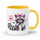 A white ceramic mug with a yellow interior and yellow handle, featuring a cute cartoon raccoon wearing pink heart-shaped sunglasses and a pink bow, holding a cup, with the text 'CUTE but FERAL' on the front. from Coffee and Moo.