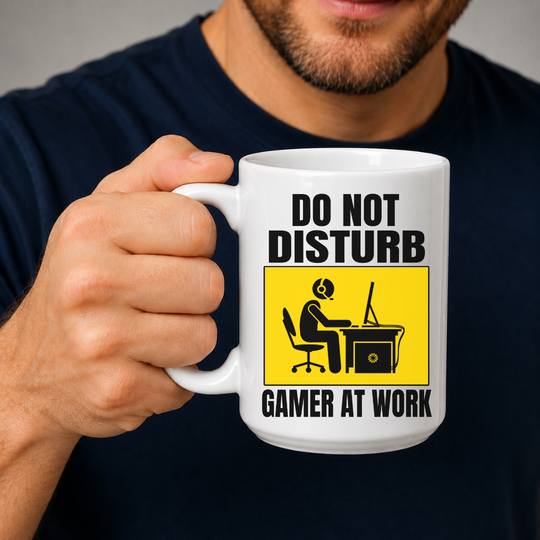 Male holding Do Not Disturb Gamer at Work gaming coffee mug, showcasing the bold warning-style design, by Coffee and Moo