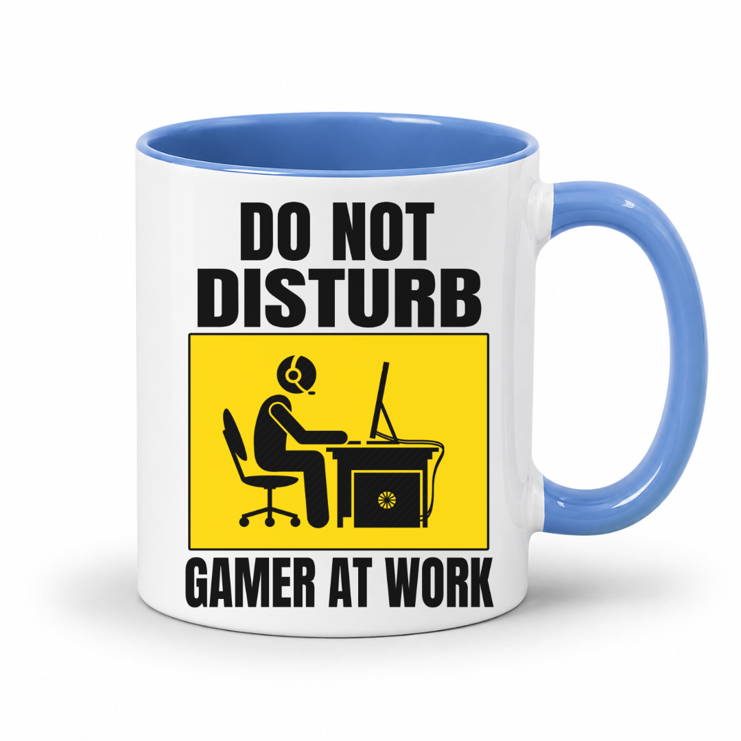 Do Not Disturb Gamer at Work gaming coffee mug featuring blue inner & handle, bold black lettering and a yellow and black graphic of a gamer at a computer, from Coffee and Moo.

