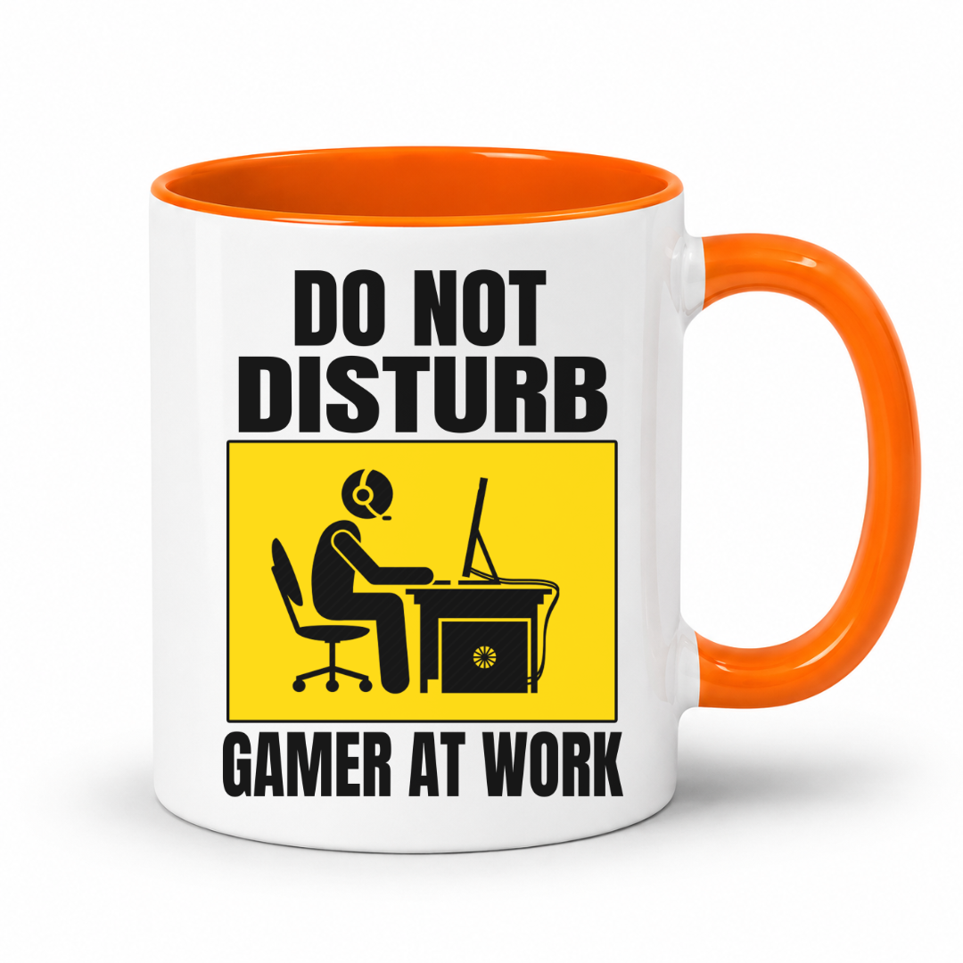 Do Not Disturb Gamer at Work gaming coffee mug featuring orange inner & handle, bold black lettering and a yellow and black graphic of a gamer at a computer, from Coffee and Moo.