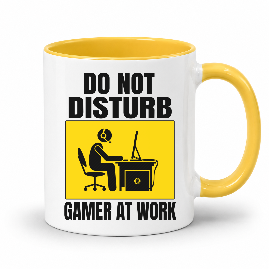 Do Not Disturb Gamer at Work gaming coffee mug featuring yellow inner & handle, bold black lettering and a yellow and black graphic of a gamer at a computer, from Coffee and Moo.
