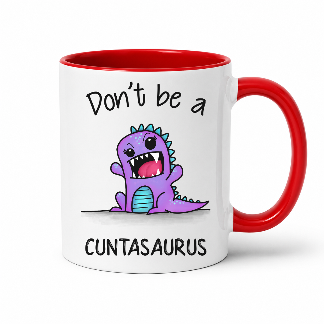 A white ceramic coffee mug with a red interior, red handle, and a cartoon purple dinosaur graphic with the text 'Don't be a CUNTASaurus' on the front, shown on a white background. Grab yours from Coffee and Moo NZ.
