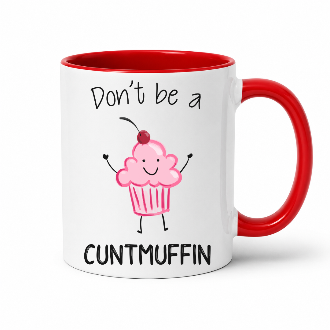 A white ceramic mug with a red interior and red handle, featuring a cute pink cupcake graphic and the text 'Don't be a CUNTMUFFIN' in black lettering. Grab yours from Coffee and Moo NZ.