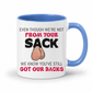 A white ceramic coffee mug with a blue interior and handle, has a humorous graphic. The mug features the text 'EVEN THOUGH WE'RE NOT FROM YOUR SACK WE KNOW YOU'VE STILL GOT OUR BACKS' in black and red lettering, accompanied by a cartoon drawing of a hairy balls. Grab your mug from Coffee and Moo NZ.