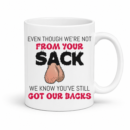 A white ceramic coffee mug with a humorous graphic. The mug features the text 'EVEN THOUGH WE'RE NOT FROM YOUR SACK WE KNOW YOU'VE STILL GOT OUR BACKS' in black and red lettering, accompanied by a cartoon drawing of a hairy balls. Grab your mug from Coffee and Moo NZ.