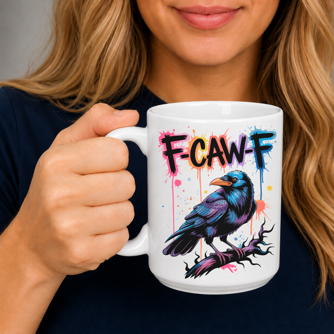 A woman holding a white ceramic mug with a colorful graphic of a raven and the text 'F-CAW-F' in a graffiti-style font.