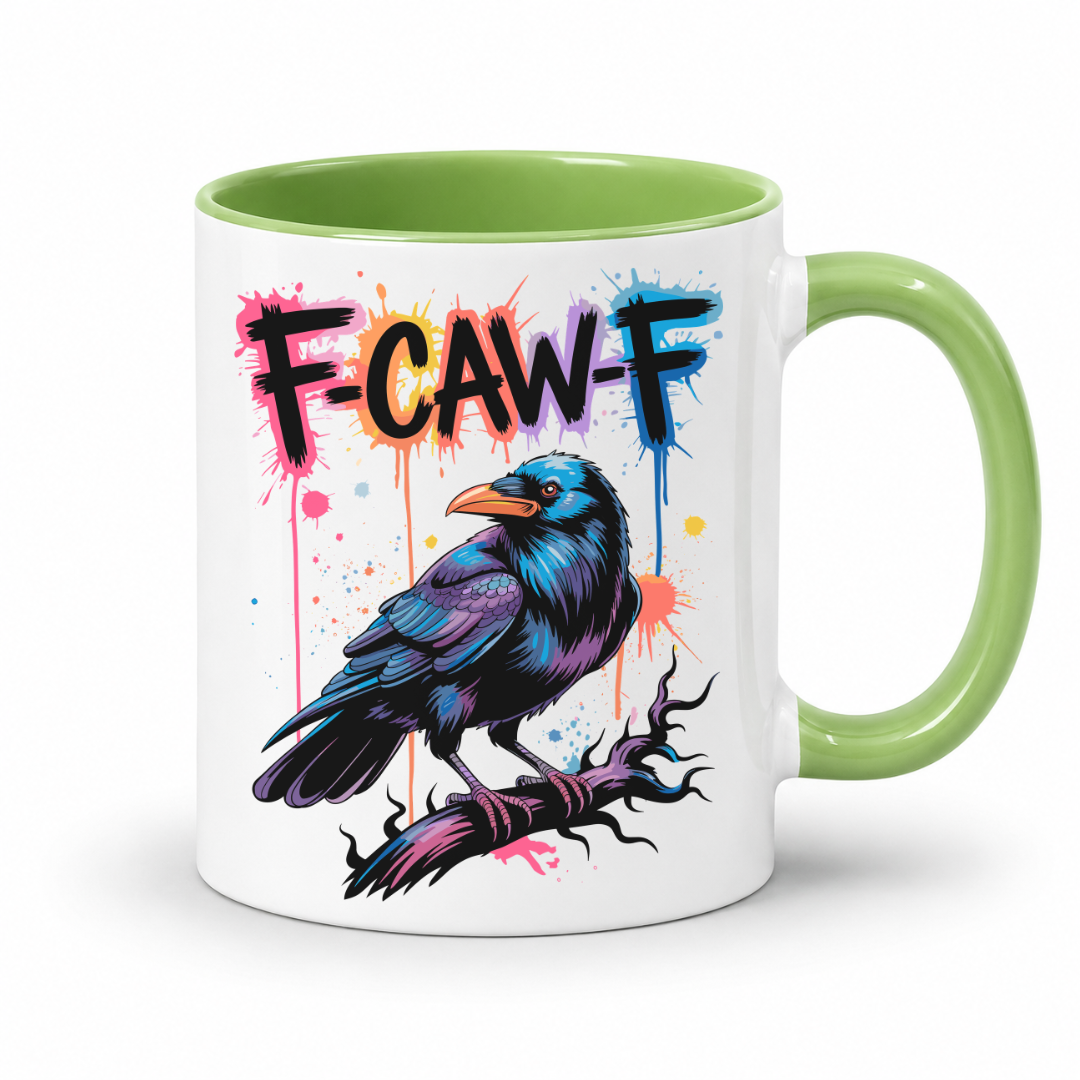 A white ceramic mug with a light green handle and interior, featuring a colorful graphic of a raven on a branch with the text 'F-CAW-F' in black, orange, and blue paint-splatter style.