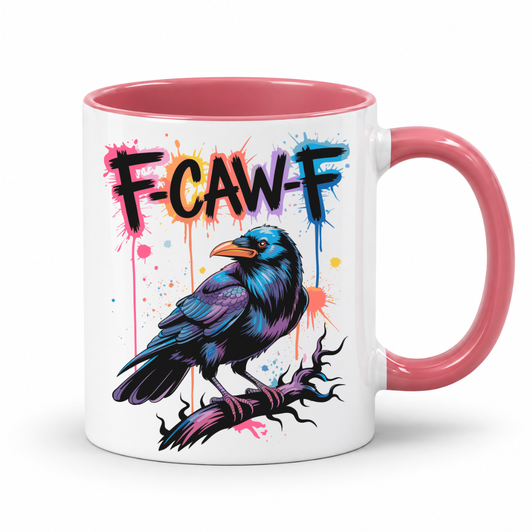 A white ceramic mug with a pink interior and handle, featuring a colorful graphic of a raven on a branch with the text 'F-CAW-F' in black outlined lettering over pink, orange, and blue paint splatters.
