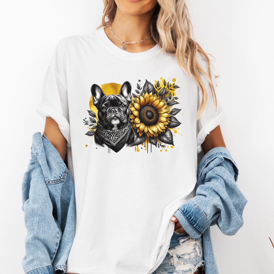 A woman wearing an oversized white graphic t-shirt with a French Bulldog and sunflower print, styled with a light blue denim jacket draped off her shoulders. Grab your tee from Coffee and Moo NZ.