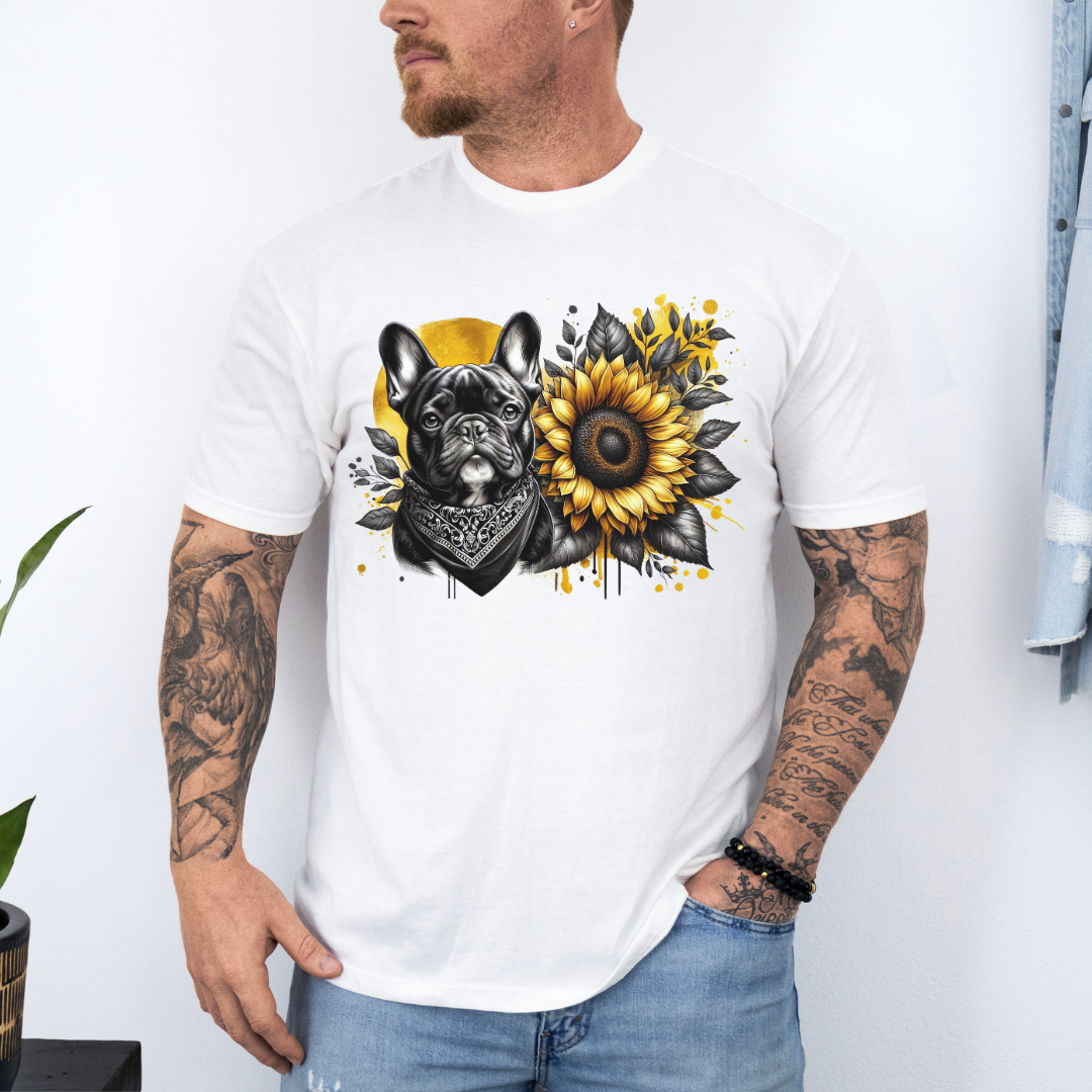 A man wearing a white graphic t-shirt featuring a French Bulldog and a sunflower design, paired with light blue jeans against a white wall. Grab your tee from Coffee and Moo NZ.